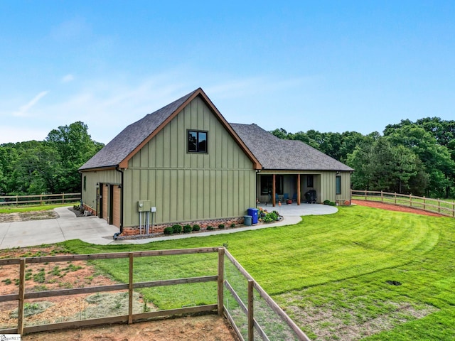 475 Johnson Rd, Easley, SC 29642 - back of property featuring a shingled roof, board and batten siding, a garage, concrete driveway, and a patio area