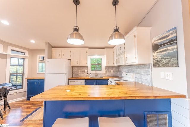1230 Melton Rd Unit # 16, West Union, SC 29696 - kitchen featuring white appliances, butcher block counters, white cabinetry, wood finished floors, and a peninsula