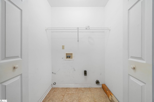 washroom with washer hookup and baseboards
