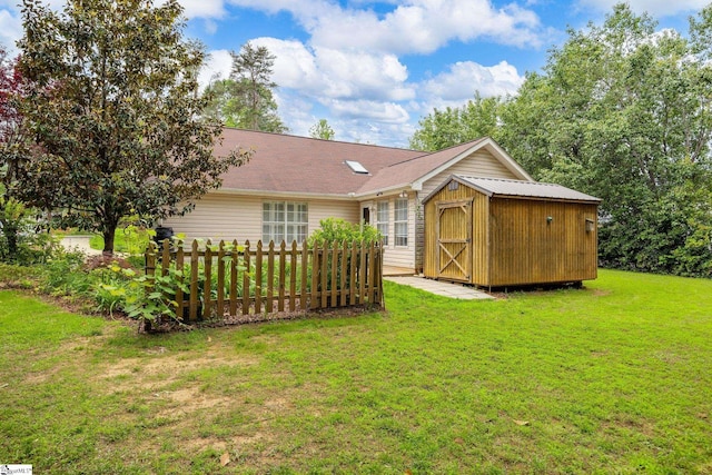 back of property with a storage shed, an outbuilding, and a yard