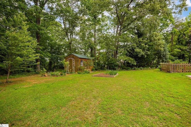 view of yard featuring a storage shed and an outbuilding