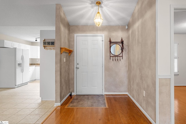 entryway featuring light wood finished floors and baseboards