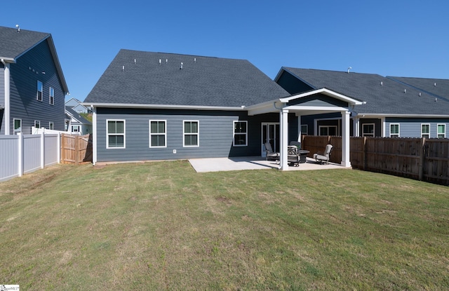 back of house with a patio area and a shingled roof