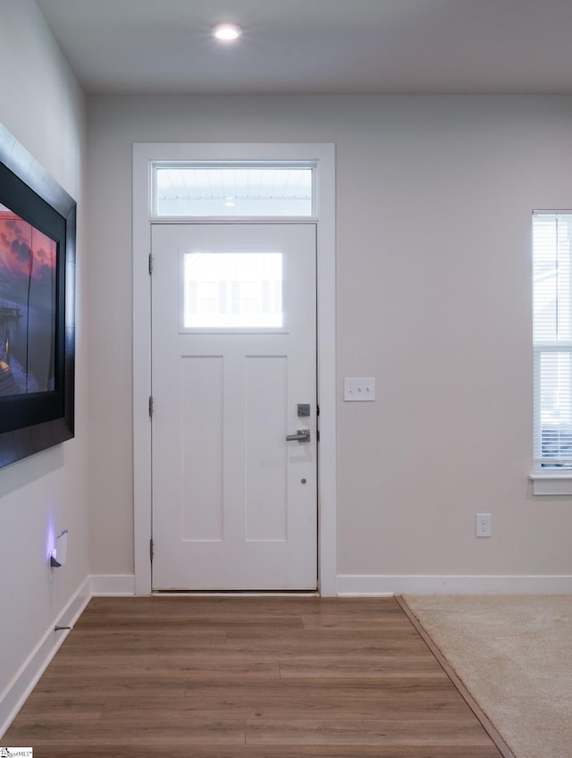 entrance foyer with baseboards, wood finished floors, and recessed lighting