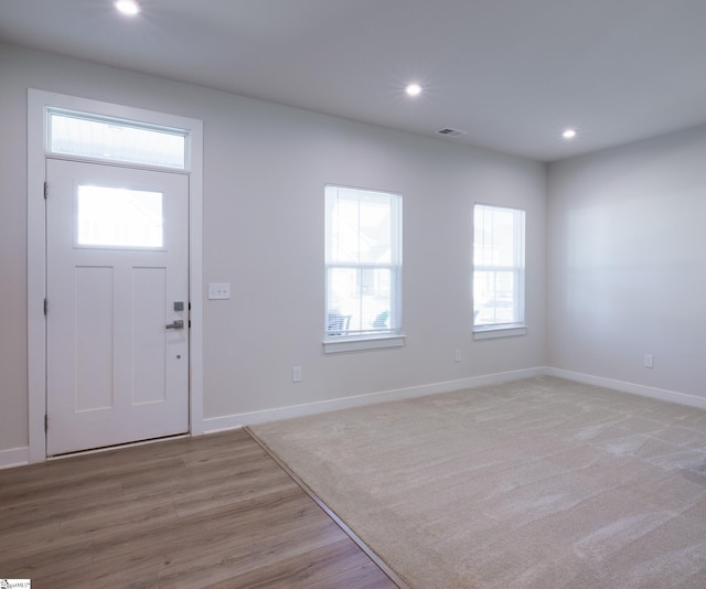 foyer with recessed lighting, baseboards, and light wood-style flooring