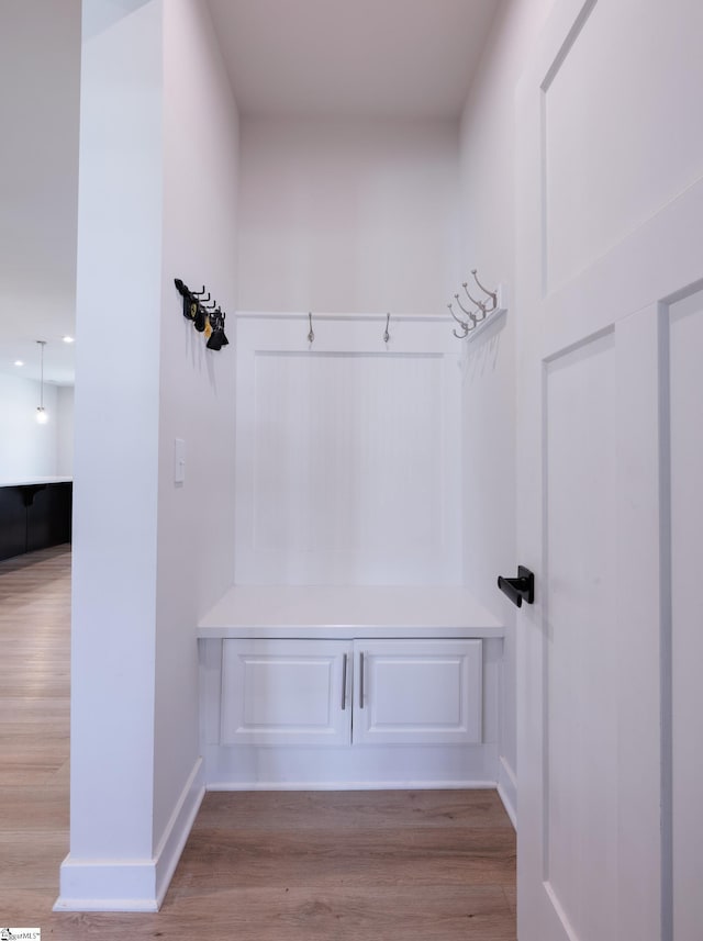 mudroom featuring wood finished floors and baseboards