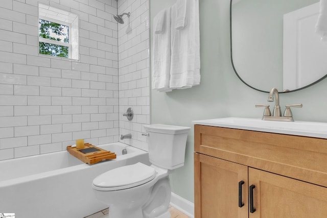 bathroom with toilet, vanity, tub / shower combination, and baseboards
