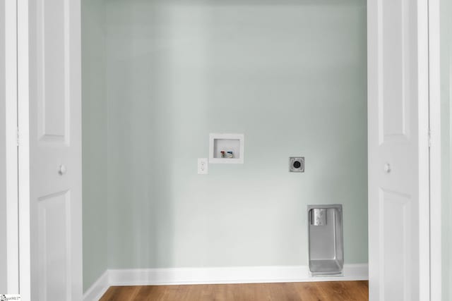 laundry area with hookup for a washing machine, baseboards, electric dryer hookup, and wood finished floors