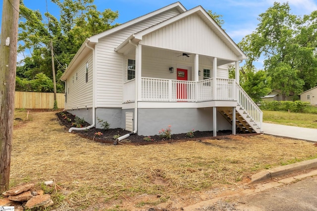 bungalow with a porch, fence, and stairs