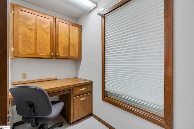 office space featuring built in desk and baseboards