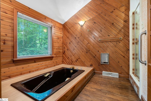 bathroom with a bathtub, plenty of natural light, an enclosed shower, wood walls, and lofted ceiling