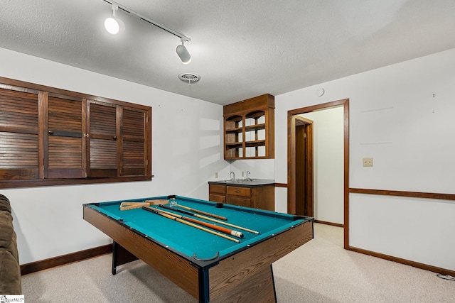rec room featuring bar with sink, rail lighting, light colored carpet, baseboards, and billiards table