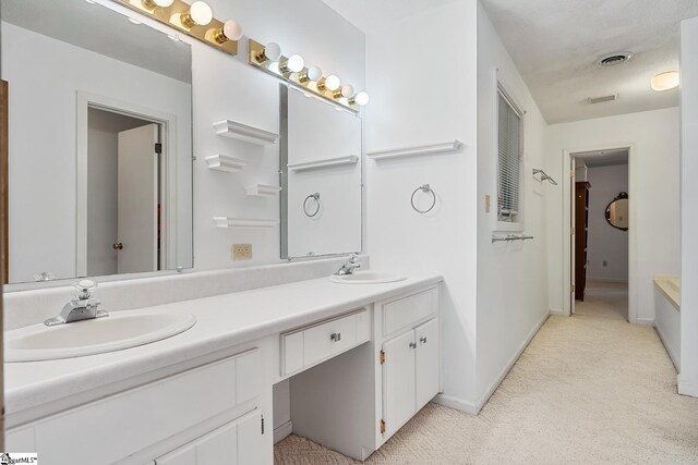 full bath with double vanity, baseboards, and carpet floors