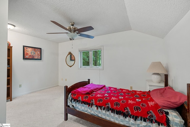 carpeted bedroom featuring a textured ceiling, ceiling fan, baseboards, and vaulted ceiling