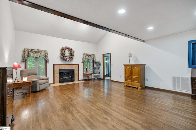 living room featuring a tile fireplace, wood finished floors, recessed lighting, and baseboards