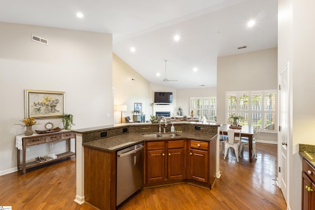 208 Medoc Ln, Moore, SC 29369 - kitchen featuring stainless steel dishwasher, a sink, a fireplace, high vaulted ceiling, and dark stone countertops