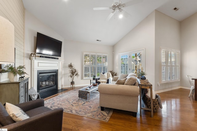 208 Medoc Ln, Moore, SC 29369 - living room featuring ceiling fan, wood finished floors, a glass covered fireplace, high vaulted ceiling, and baseboards