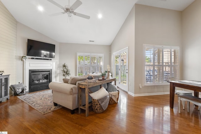 208 Medoc Ln, Moore, SC 29369 - living room with high vaulted ceiling, wood finished floors, a ceiling fan, a fireplace with flush hearth, and baseboards