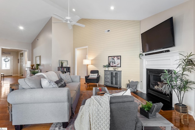 208 Medoc Ln, Moore, SC 29369 - living area featuring high vaulted ceiling, wood finished floors, ceiling fan, wooden walls, and baseboards