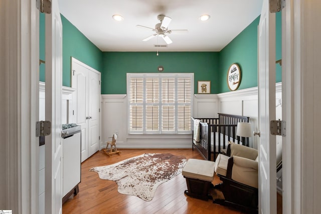 208 Medoc Ln, Moore, SC 29369 - bedroom with wainscoting, a decorative wall, wood finished floors, ceiling fan, and recessed lighting
