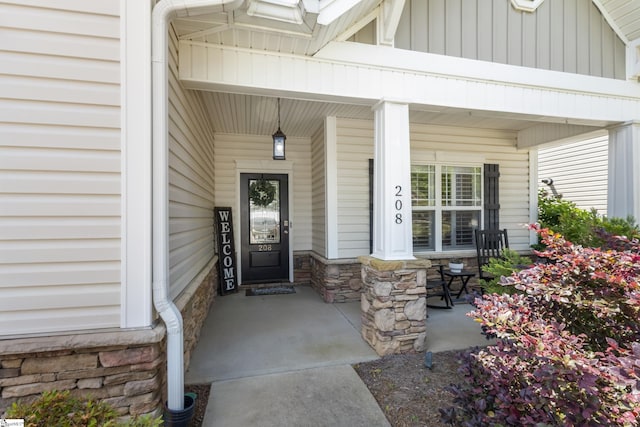 208 Medoc Ln, Moore, SC 29369 - property entrance featuring stone siding, a porch, and board and batten siding