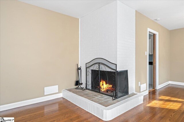 222 Woodview Ave, Spartanburg, SC 29306 - detailed view of a fireplace, wood finished floors, and baseboards