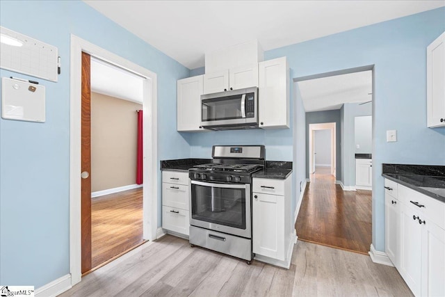 222 Woodview Ave, Spartanburg, SC 29306 - kitchen featuring appliances with stainless steel finishes, light wood-style floors, white cabinets, and baseboards