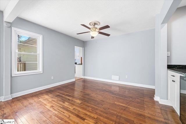 222 Woodview Ave, Spartanburg, SC 29306 - unfurnished living room featuring ceiling fan, dark wood-type flooring, baseboards, and a textured ceiling