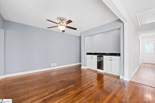 222 Woodview Ave, Spartanburg, SC 29306 - unfurnished living room featuring wood finished floors, beverage cooler, ceiling fan, baseboards, and a textured ceiling