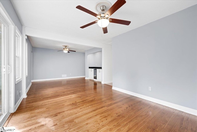 222 Woodview Ave, Spartanburg, SC 29306 - unfurnished living room featuring a ceiling fan, baseboards, and light wood finished floors