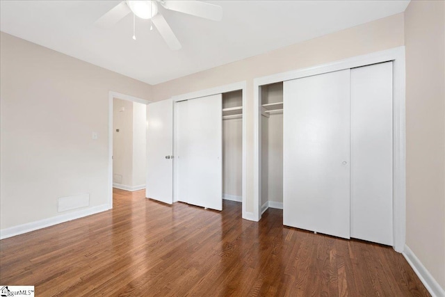 222 Woodview Ave, Spartanburg, SC 29306 - unfurnished bedroom featuring multiple closets, wood finished floors, baseboards, and a ceiling fan