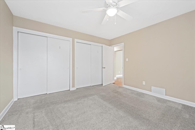 222 Woodview Ave, Spartanburg, SC 29306 - unfurnished bedroom with multiple closets, carpet flooring, baseboards, and a ceiling fan