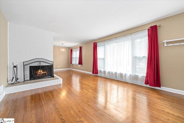 222 Woodview Ave, Spartanburg, SC 29306 - unfurnished living room featuring a fireplace, wood finished floors, and baseboards