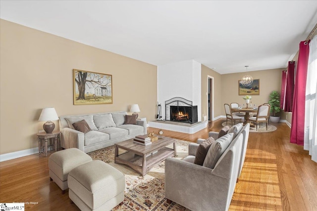 222 Woodview Ave, Spartanburg, SC 29306 - living area with light wood-style flooring, a chandelier, a multi sided fireplace, and baseboards