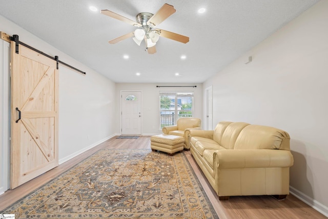 330 Split Oak Ln, Inman, SC 29349 - living room with a barn door, light wood finished floors, a ceiling fan, baseboards, and recessed lighting