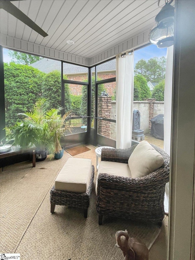 sunroom / solarium with carpet