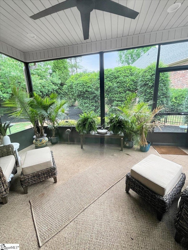 sunroom featuring a ceiling fan and healthy amount of natural light