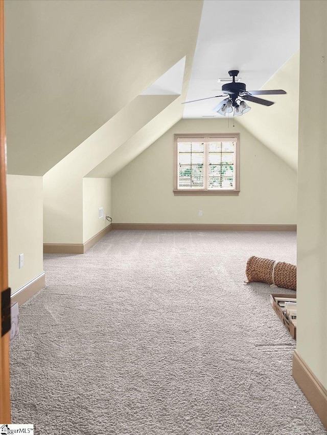 additional living space featuring carpet flooring, ceiling fan, lofted ceiling, and baseboards