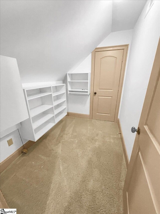 bonus room featuring vaulted ceiling, carpet floors, and baseboards