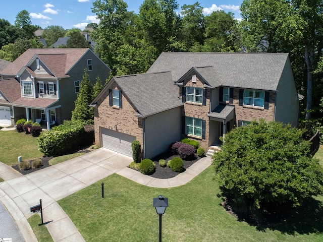 craftsman house featuring concrete driveway, brick siding, an attached garage, and a front lawn