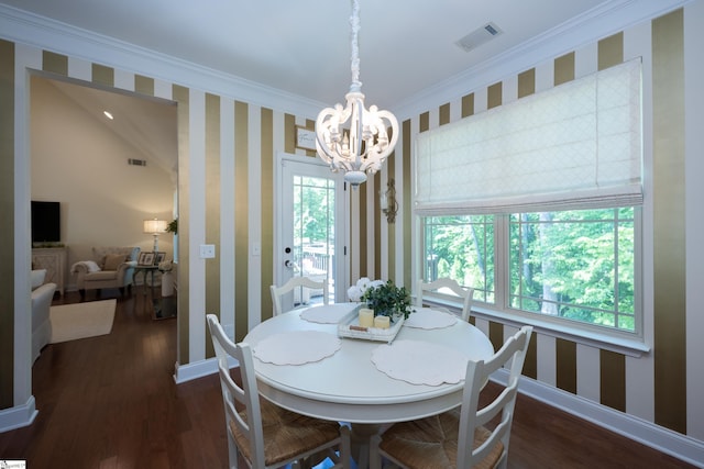 dining area featuring wallpapered walls, a chandelier, wood finished floors, crown molding, and baseboards