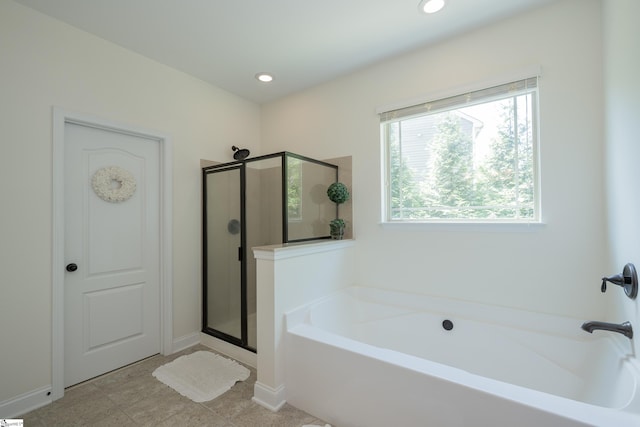 bathroom with a stall shower, a garden tub, and recessed lighting