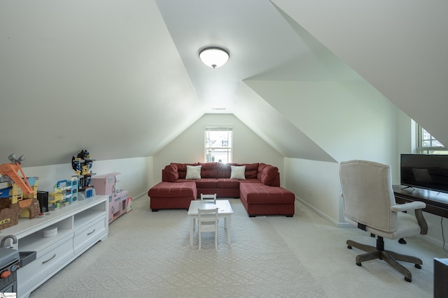 office featuring light colored carpet, vaulted ceiling, and baseboards