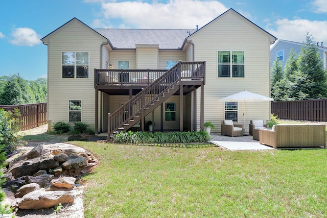 rear view of house with stairway, a wooden deck, outdoor lounge area, a patio, and roof with shingles