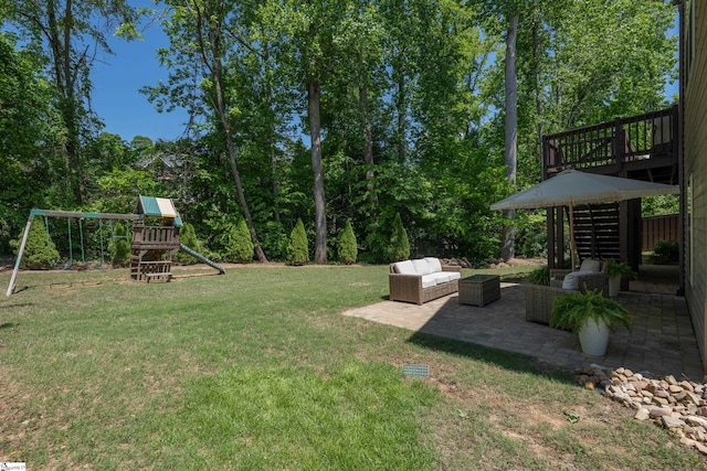 view of green lawn with a patio, stairway, a playground, outdoor lounge area, and a wooden deck