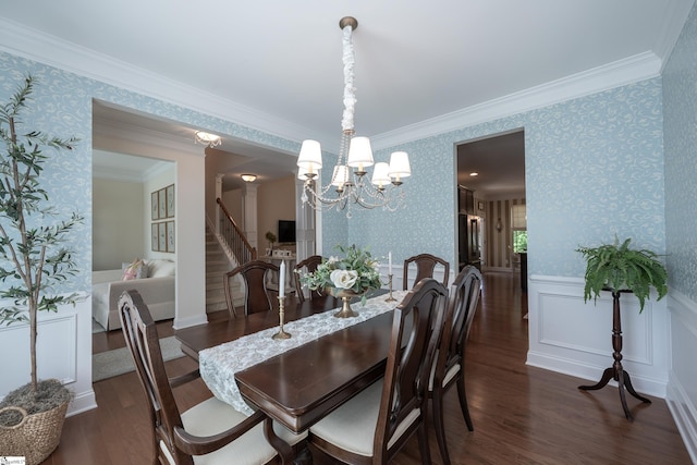 dining space featuring wallpapered walls, dark wood-type flooring, a chandelier, a wainscoted wall, and stairway