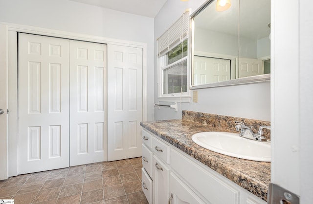 bathroom with vanity and stone finish flooring