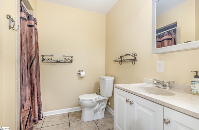 full bathroom with toilet, vanity, baseboards, and tile patterned floors