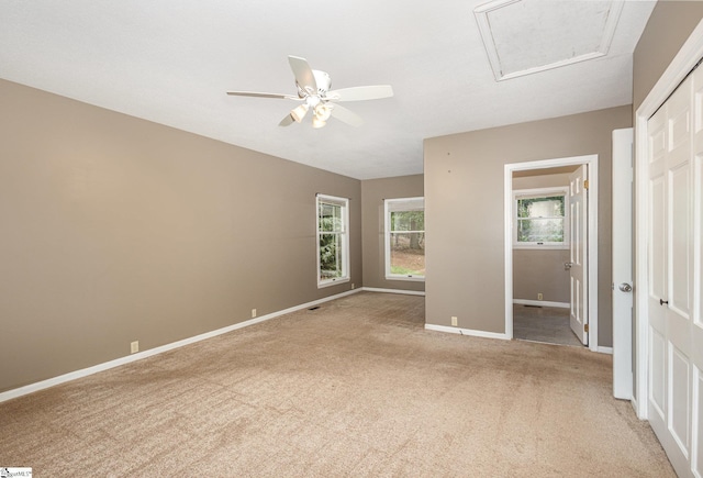 unfurnished bedroom with light colored carpet, baseboards, a closet, and ceiling fan