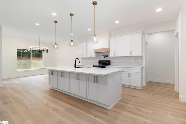 kitchen with black range with electric stovetop, a sink, baseboards, tasteful backsplash, and recessed lighting